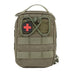 A closed, olive green rectangular emergency kit bag is shown against a white background. A red and black medical cross patch is prominently displayed on the front. The bag features a carrying handle on top and multiple horizontal and vertical straps of olive green webbing across the front.