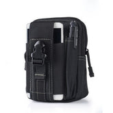 A black tactical waist bag with multiple pockets and straps is shown against a white background. A white smartphone is partially visible in an outer pocket, and a black pen is in a side loop. A black buckle closure is visible on the main flap.