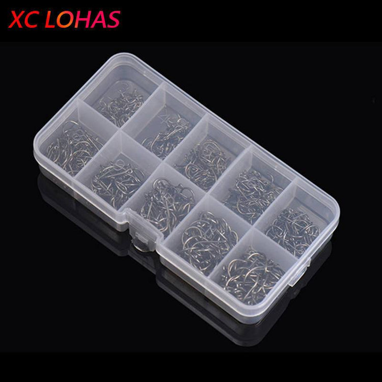 A clear plastic tackle box with ten compartments, each filled with numerous silver circle fishing hooks of varying sizes. The "XC LOHAS" logo is visible in the upper left corner.