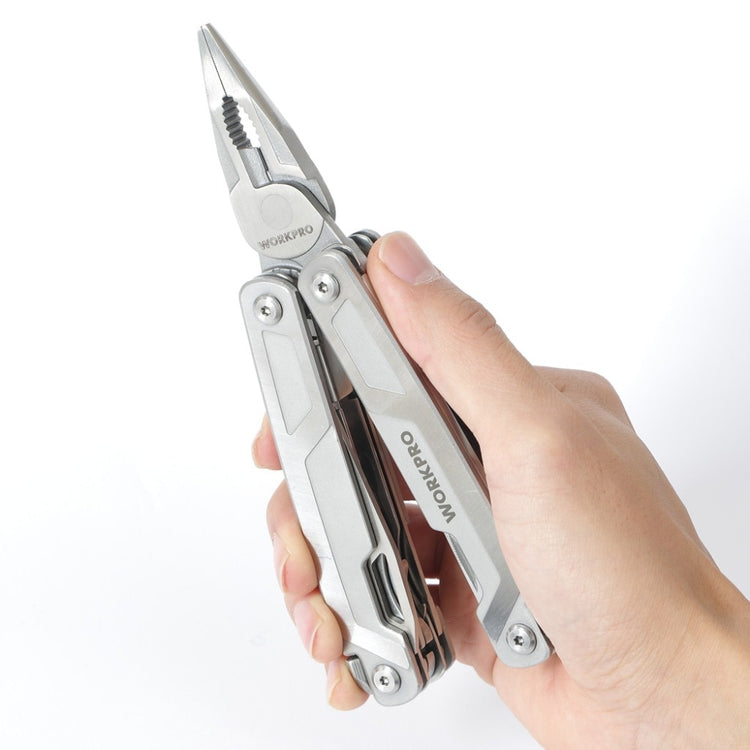 A silver WORKPRO multi-tool with pliers extended is held in a hand against a blurred white background. The tool features a folding design with various other tools visible along the handles. The WORKPRO logo is printed on one of the handles.