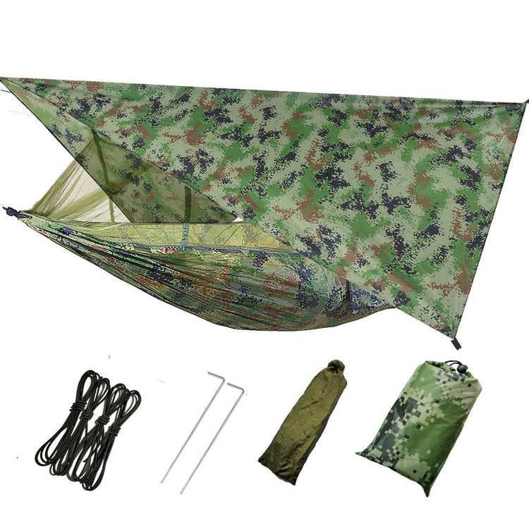 A camouflage double camping hammock with an attached mosquito net and a camouflage rain fly tarp suspended above it is shown. Below are the included accessories: black ropes, silver stakes, and two stuff sacks (one olive green, one camouflage).