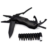 A black, folded multifunctional tool with pliers extended at the top left and a partially unfolded serrated knife blade visible on the left. Below the tool are nine black screwdriver bits arranged in a row, along with a silver magnetic bit holder.