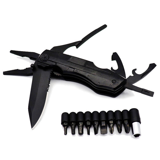 A black, folded multifunctional tool with pliers extended at the top left and a partially unfolded serrated knife blade visible on the left. Below the tool are nine black screwdriver bits arranged in a row, along with a silver magnetic bit holder.