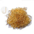A pile of approximately 100 small, golden-colored fly fishing hooks with barbs, and a close-up inset of a single hook showing its shape.