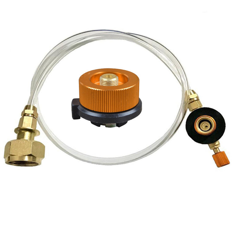 A clear hose with brass fittings on either end is shown against a white background. One end has a large hexagonal brass nut, while the other end has a black circular valve with a smaller brass fitting and an orange knob.