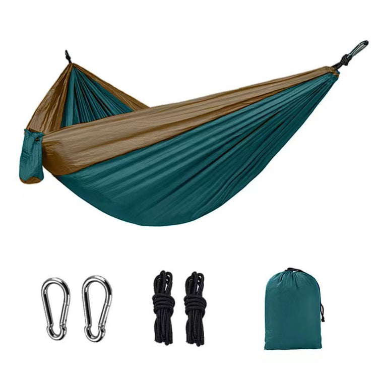 A two-tone (brown and teal) parachute fabric hammock suspended in the air, along with two silver carabiners, two bundles of black rope, and a teal drawstring storage bag laid out below.
