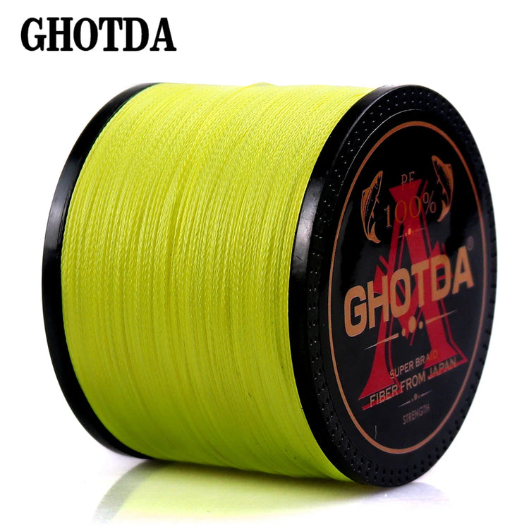 A spool of bright yellow GHOTDA super braid fishing line with black end caps. The label features the GHOTDA brand name and indicates "Super Braid" and "Fibers From Japan.