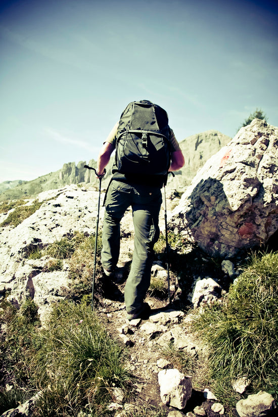 man climbing cliff