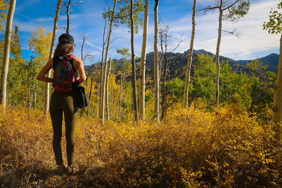 women wearing green leggings near trees during daytime