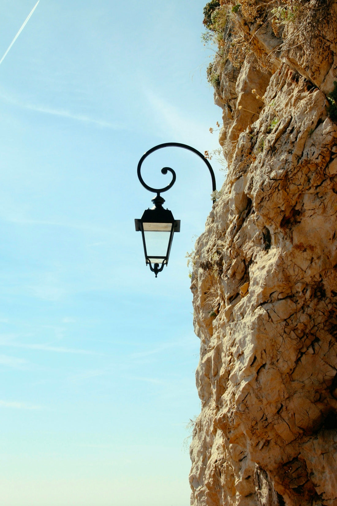 black street light on brown rock formation during daytime
