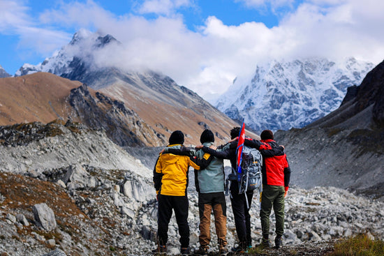 a group of people with skis on a mountain
