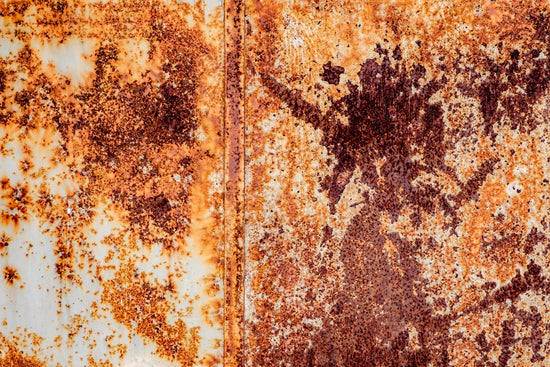 a rusted metal surface with a flower on it