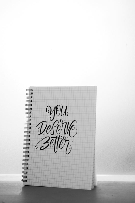 a spiral notebook with a handwritten quote on it