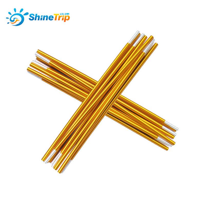 Two sets of gold-colored ShineTrip aluminum alloy tent pole segments are crossed over each other against a white background. Each set appears to consist of multiple interconnected sections with silver-colored ferrules at the ends. The ShineTrip logo is visible in the upper left corner.