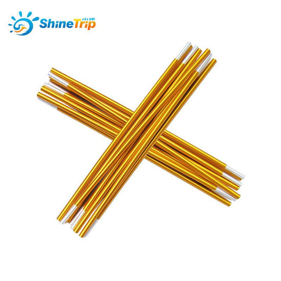 Two sets of gold-colored ShineTrip aluminum alloy tent pole segments are crossed over each other against a white background. Each set appears to consist of multiple interconnected sections with silver-colored ferrules at the ends. The ShineTrip logo is visible in the upper left corner.