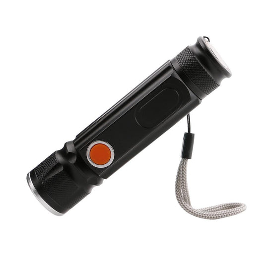 A small black LED flashlight with a textured grip, a zoomable head, an orange power button, a built-in magnet, and a lanyard is shown diagonally against a white background.