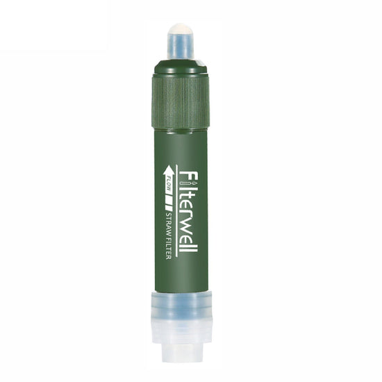  A green, cylindrical water filter straw is shown with its components displayed below: a clear water bag with a cap and carabiner, a black backflushing syringe, a clear flexible hose, and a green lanyard with a white clip. Text next to the straw lists "Degerming," "Remove odor," and "Heavy metal removal.