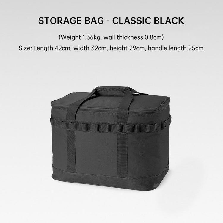 A rectangular black camping storage bag with a zippered top, carrying handles on the top and sides, and webbing loops around the exterior is shown against a light grey background. Text above the bag reads "STORAGE BAG - CLASSIC BLACK" followed by dimensions and weight.