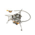A compact, foldable camping stove with three burners and silver stainless steel construction is shown against a white background. A flexible gas line is attached to the side.