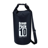A black Ocean Pack 10L waterproof dry bag with a white "Ocean Pack" logo and "10 DRY BAG" text is shown with a shoulder strap against a white background. The top of the bag is folded and buckled shut.