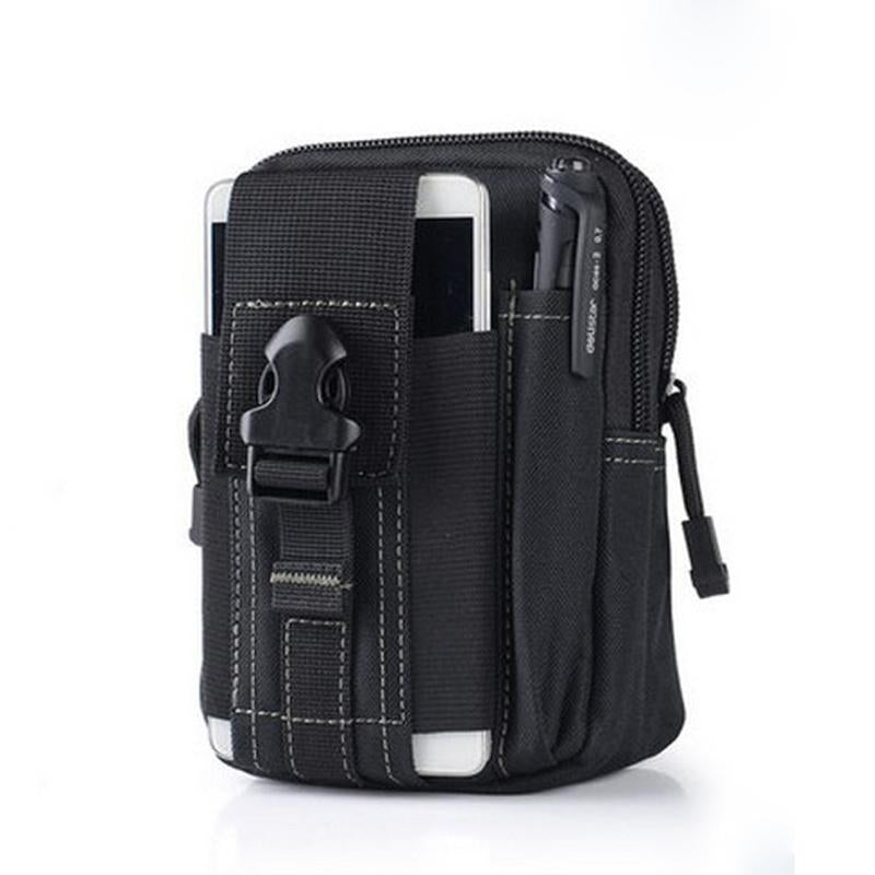 A black tactical waist bag with multiple pockets and straps is shown against a white background. A white smartphone is partially visible in an outer pocket, and a black pen is in a side loop. A black buckle closure is visible on the main flap.