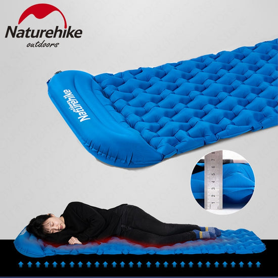 A blue inflatable camping mat with a diamond-shaped air cell pattern and an integrated pillow is shown fully inflated next to its blue stuff sack and the blue inflatable pump bag. Text indicates "Naturehike outdoors," "Inflatable Bag + Mattress (With Pillow)," dimensions, weight, and the color "Blue.