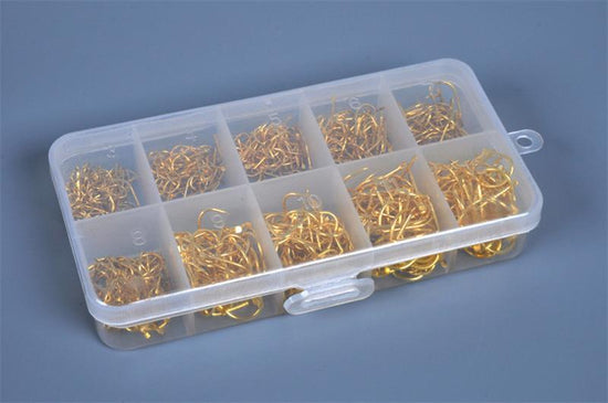 A clear plastic tackle box with ten compartments, each filled with numerous small golden-colored fishing hooks of varying sizes.
