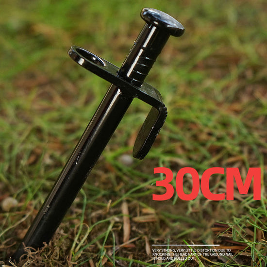 A single, black, heavy-duty steel tent ground nail with a wide head and a pointed tip, driven into grassy ground. The text "30CM" is superimposed on the image.