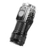 A small, black Smiling Shark mini LED flashlight with a metal clip is angled against a white background. A silver power button is visible on the side. Text on the flashlight includes "SMILING SHARK" and Chinese characters