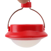 A red and white portable LED camping lantern with a silver hanging hook is shown held by a finger against a white background.