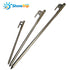 Three silver ShineTrip tent pegs of varying lengths and thicknesses are arranged diagonally against a white background. The ShineTrip logo is visible in the upper left corner. Each peg has a hooked head with a hole for attaching guy lines and a pointed tip.