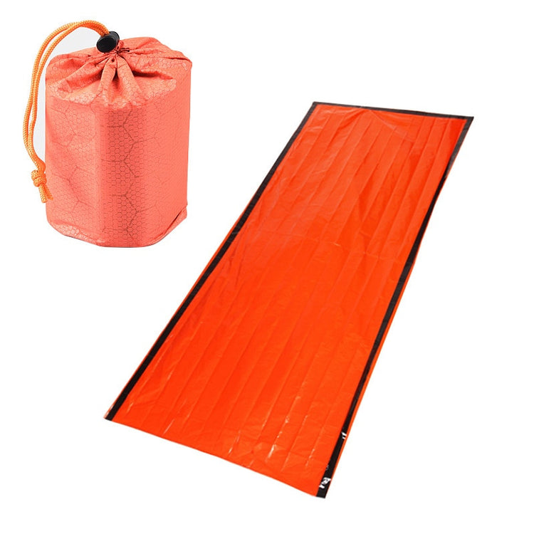 An unfolded orange emergency sleeping bag withAn unfolded orange emergency sleeping bag with black trim is shown next to its compact, drawstring storage bag made of similar orange material. black trim is shown next to its compact, drawstring storage bag made of similar orange material.