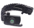 A black braided paracord survival bracelet is shown partially unbuckled, revealing a small knife blade, a compass on the buckle, and the ridged edge of a fire starter.