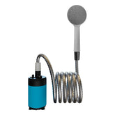  A portable electric camping shower system is shown against a white background. The main unit is a white cylinder with a black band, connected to a coiled silver hose. The hose leads to a white handheld showerhead with a grey spray face.