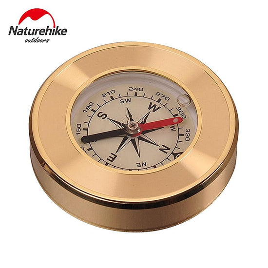 A small, round, gold-colored Naturehike compass is shown against a white background. The compass face features markings for direction (N, S, E, W) and degrees, with a black and red magnetic needle. The Naturehike Outdoors logo is visible in the upper left corner.