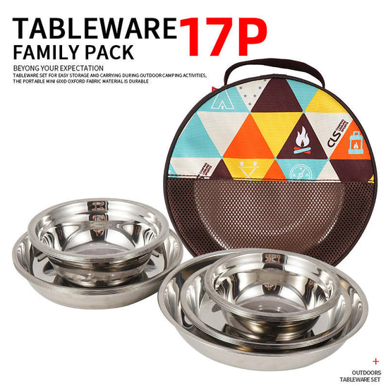 A 17-piece stainless steel camping cookware set is displayed with multiple stacks of plates and bowls arranged around a colorful circular storage bag with a mesh top.
