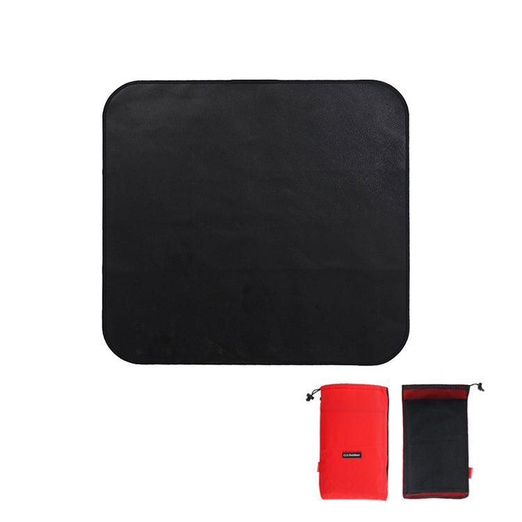 A square black fireproof mat with rounded corners is shown against a white background. Below it are two storage bags, one red and one black with a red trim.